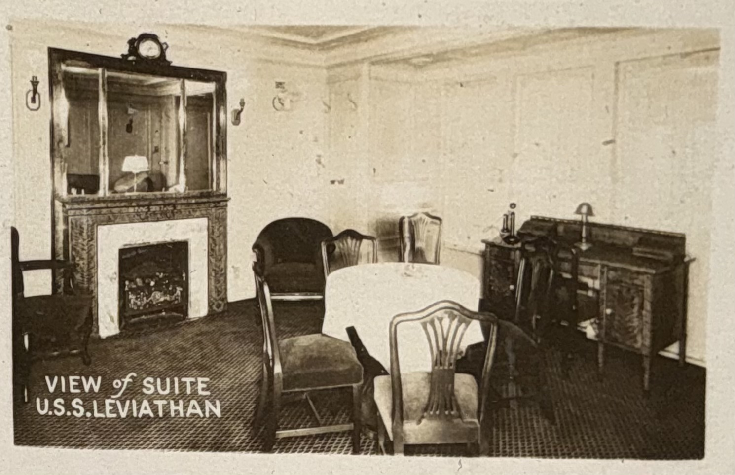 Passenger suite sitting room with fireplace and writing desk.