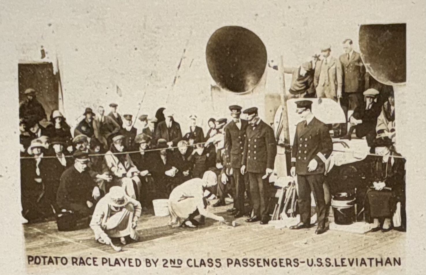 Second-class passengers taking part in a potato race on deck.