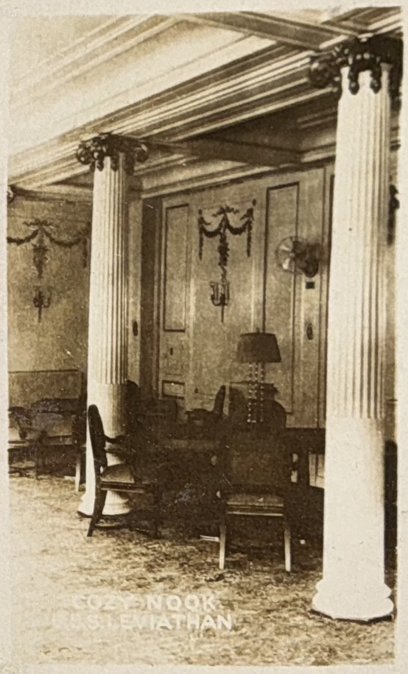Seating corner within a smoking room, with decorative columns.