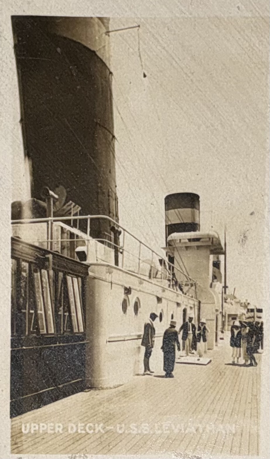 Passengers on an upper deck with funnel and deckhouse visible.